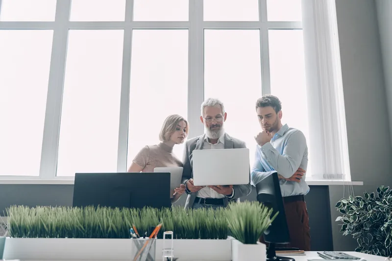 Professionals reviewing a digital workflow together